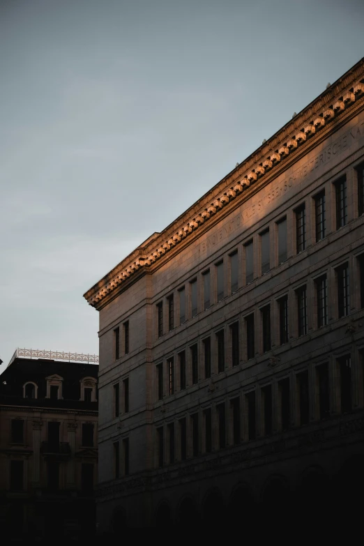 a building is illuminated with lights as seen from below