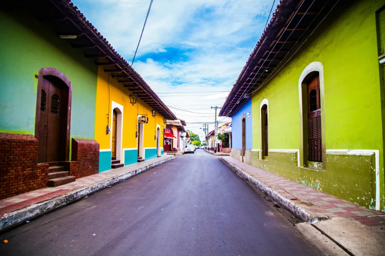 an empty city street lined with tall buildings