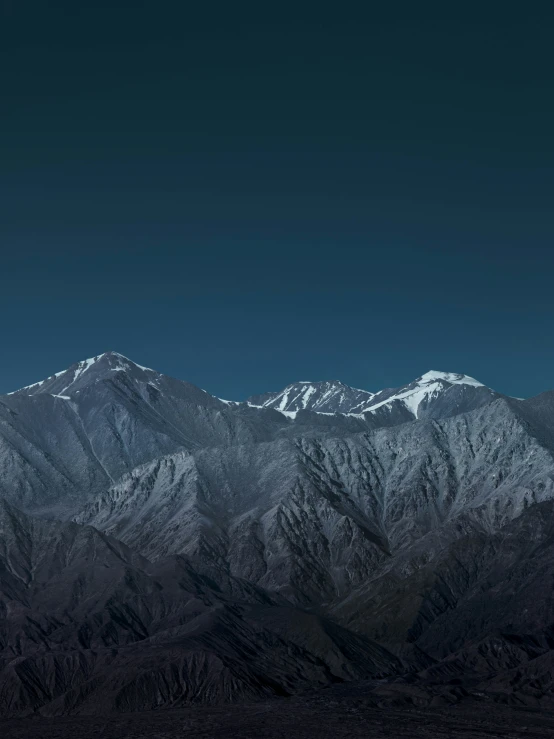 a full view of a huge mountain with a sky background