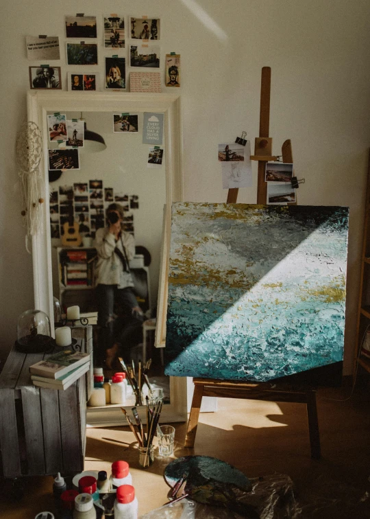 an art studio with some artist working on an abstract painting