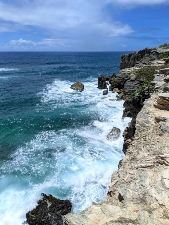 the view from the coast of waves hitting on rocks