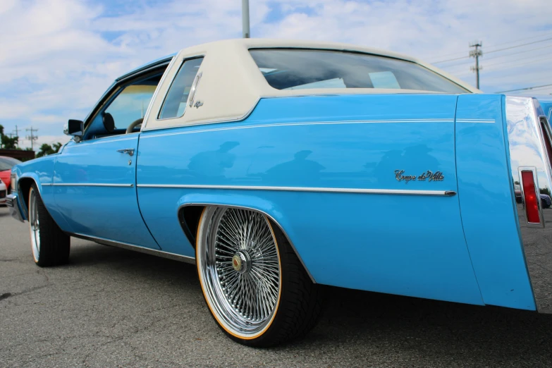 an old fashion car with its wheels showing on the road