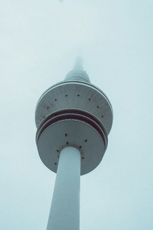 a tall white structure under a cloudy sky