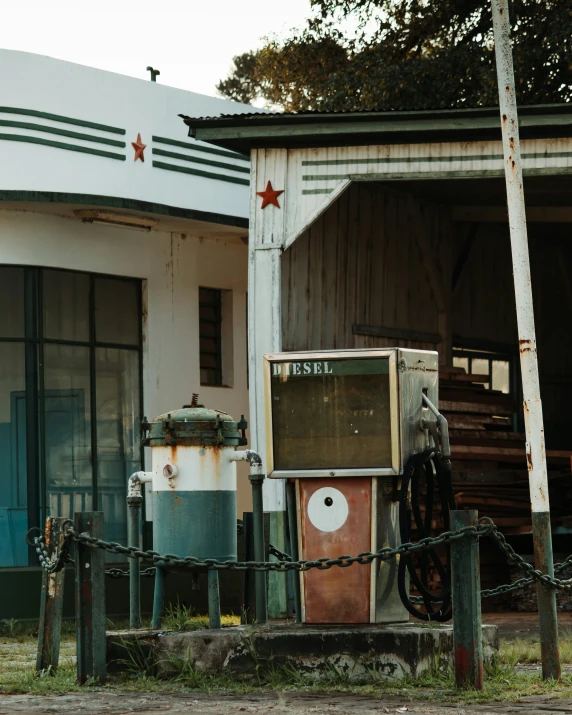 a rusted out old machine and door of an abandoned store