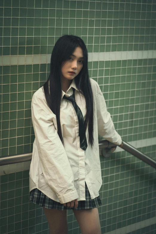 a girl with black hair in a tie and skirt