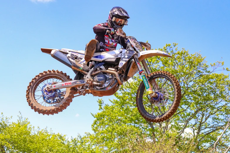 a man on a dirt bike jumping over the ground