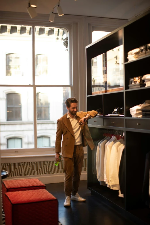 man carrying a slice of pizza in a clothing store