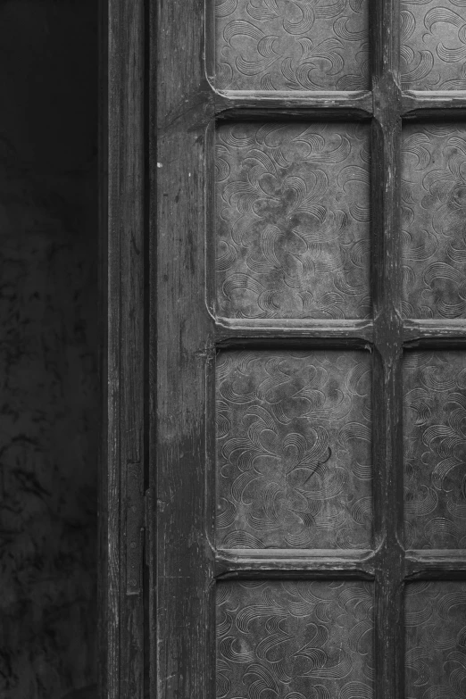 an old, very dirty door with a window pane