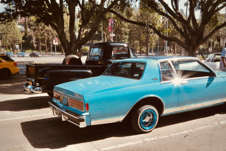 an old car is parked in a lot