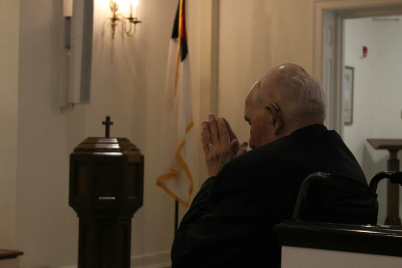 a man is praying inside the room