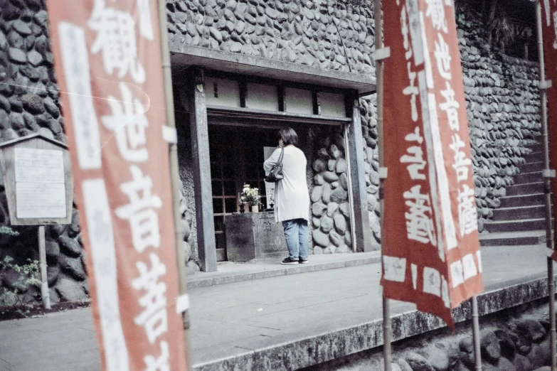 red and white banners on the outside of an oriental building