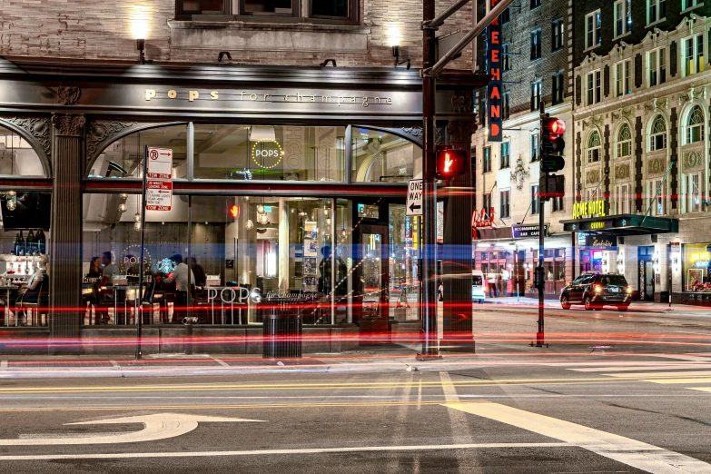 a street corner in the city lit up at night