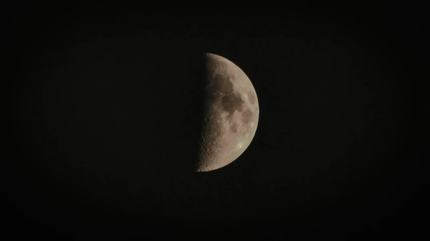 a crescent moon during a very dark night