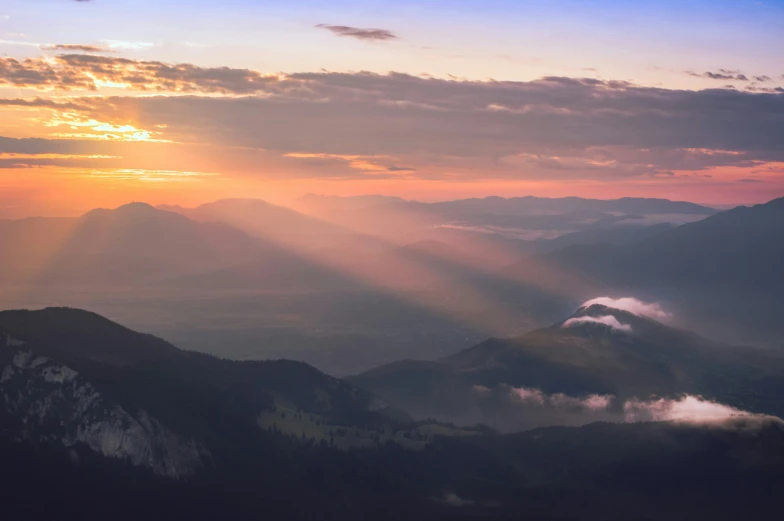 a view of mountains from above at sunset