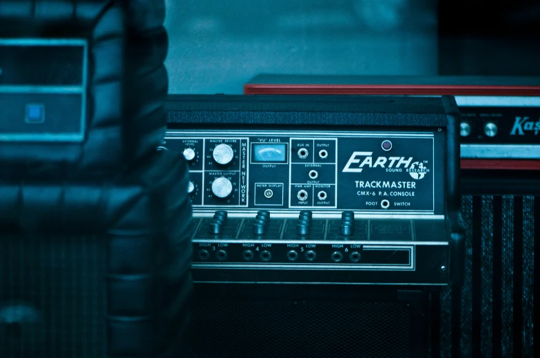 an amp with the back side up, standing next to a guitar amplifier