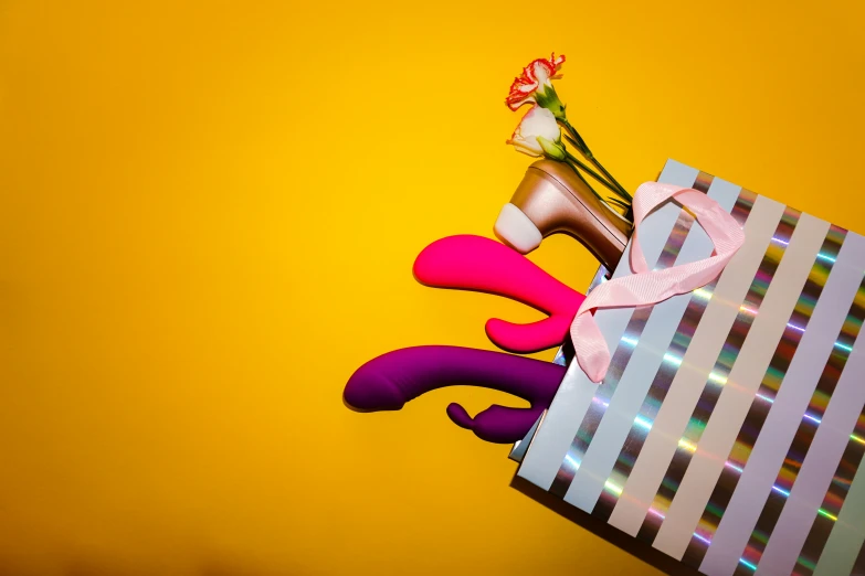 a gift bag with ribbon and shoes on it