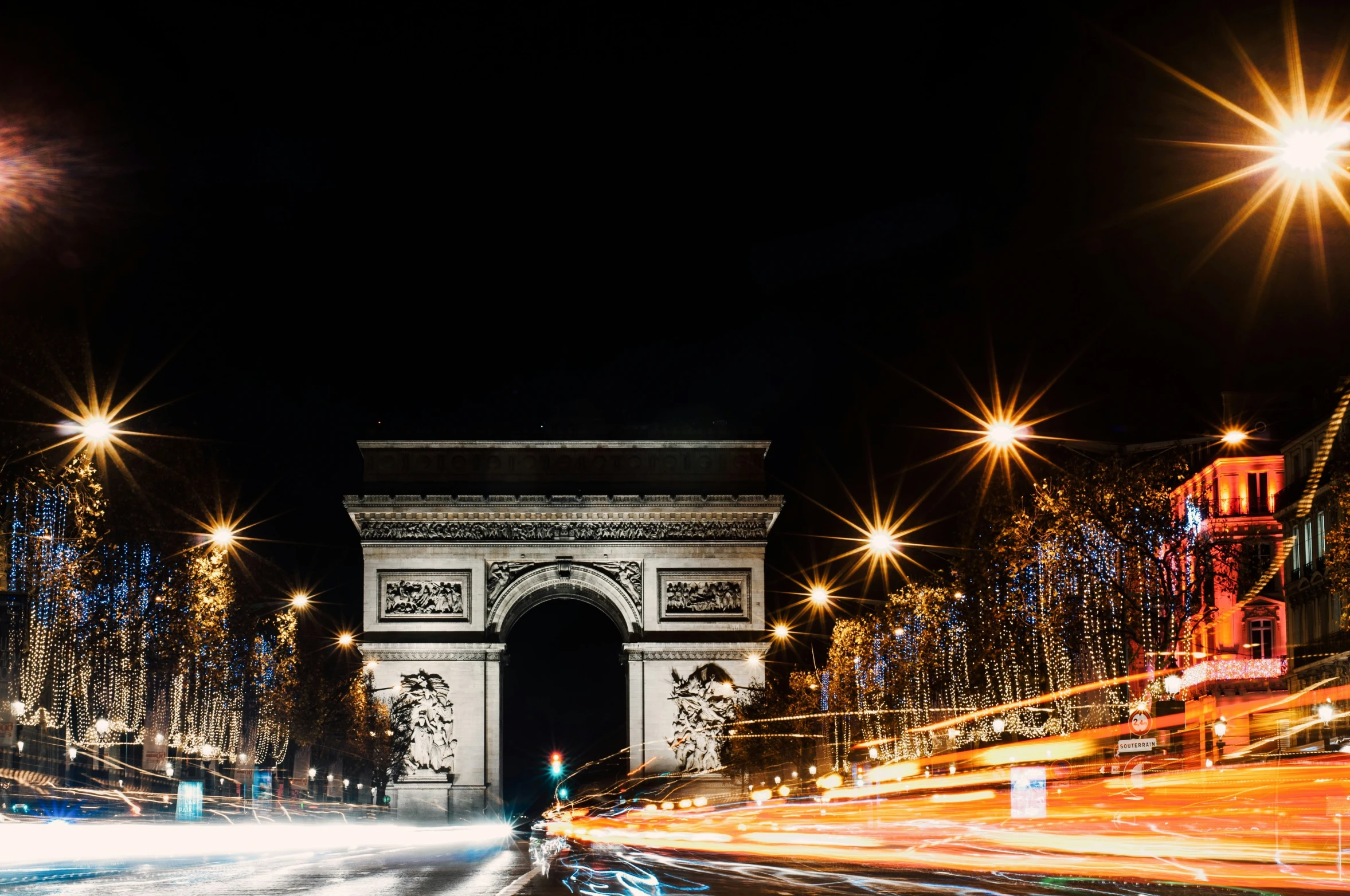 people walking in front of a city at night