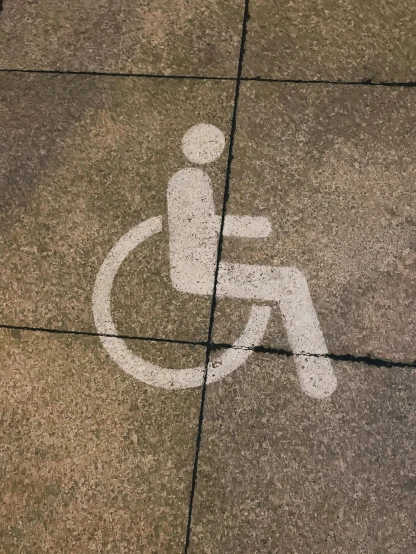 a white sign on the pavement that someone has just picked up