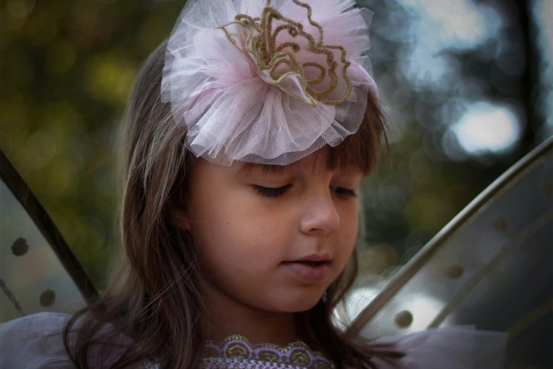  wearing feathery head band and white erfly wings