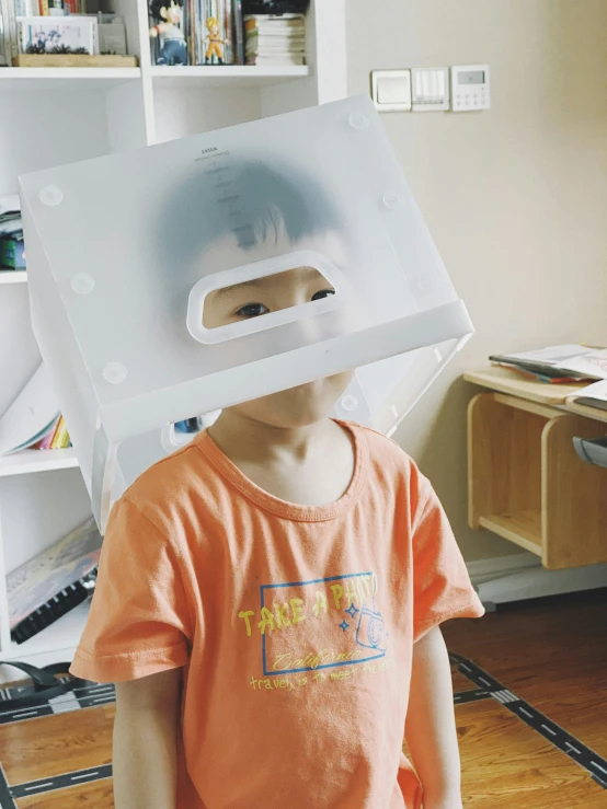 a child wearing an open face pizza box