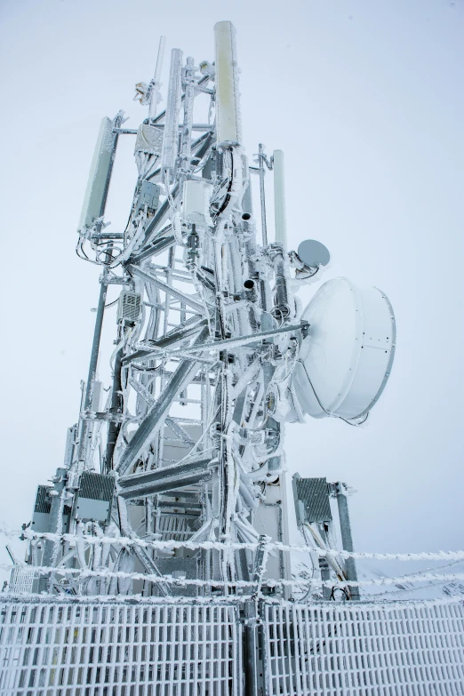 a very tall radio antenna on top of a building