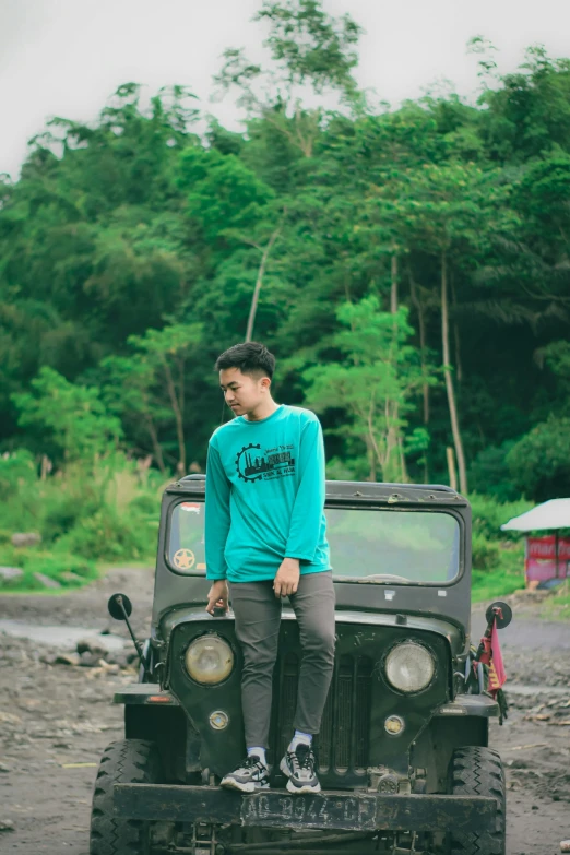 young man sitting on top of a vehicle