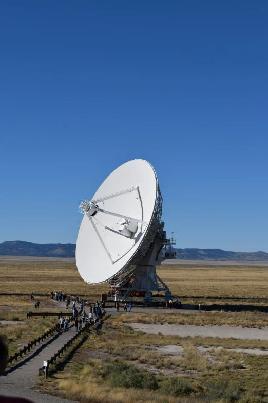 several large antennas in a desert landscape