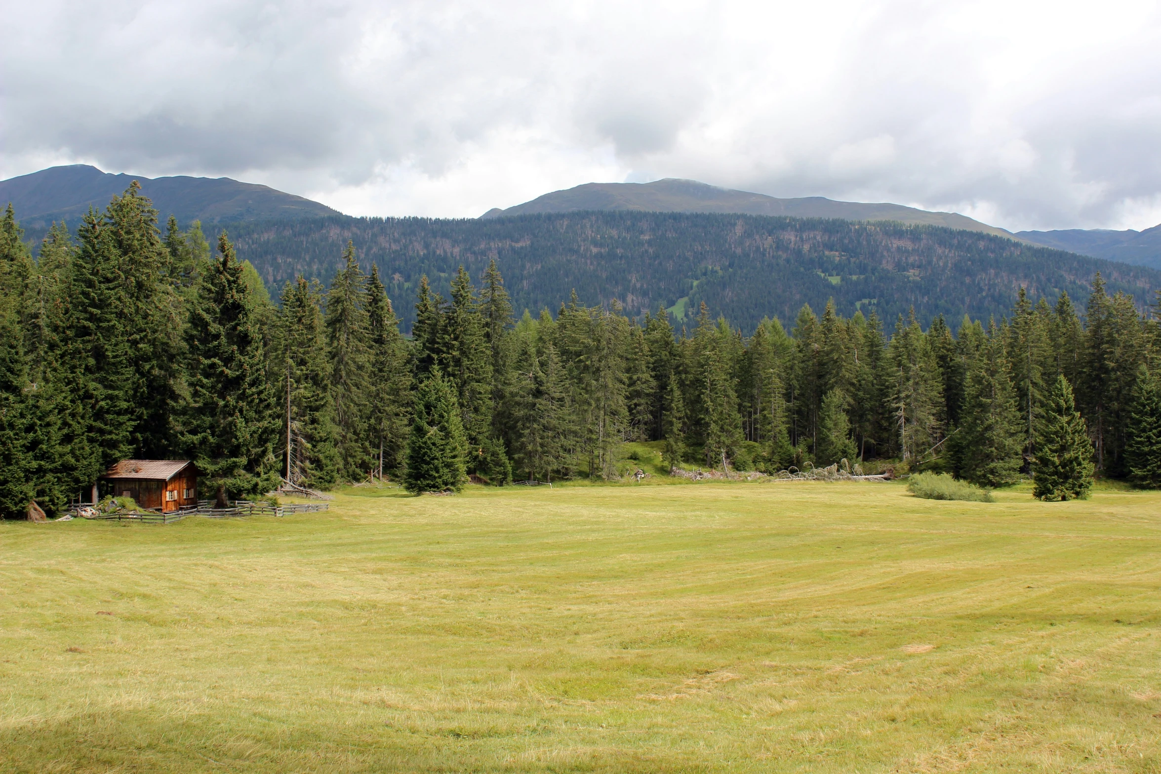 an empty open field with mountains in the background