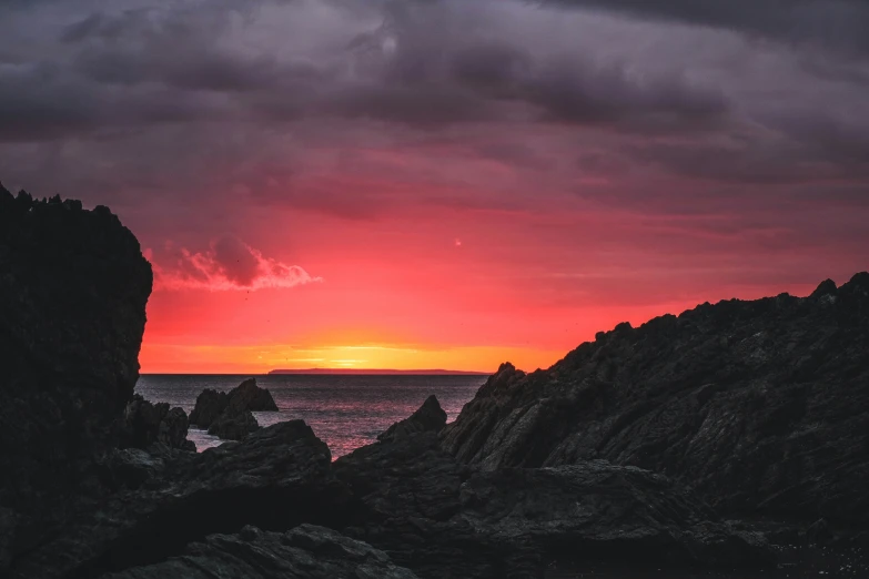 the sunset from a rock outcropping near the ocean