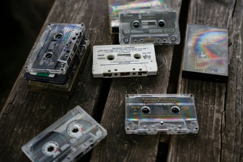 old school cassette tapes are on the wooden bench