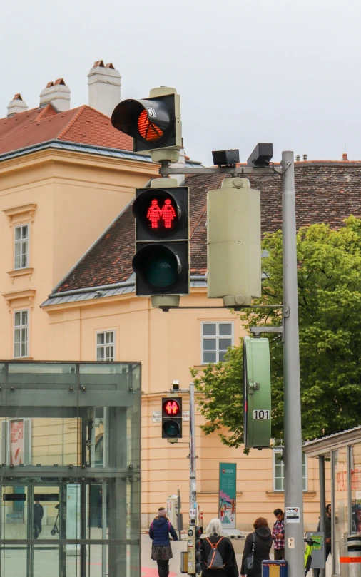 people crossing the street in front of a city center