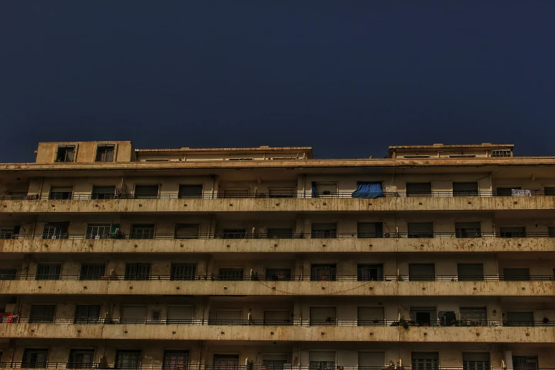 large building with balconies and balconies with night sky in background