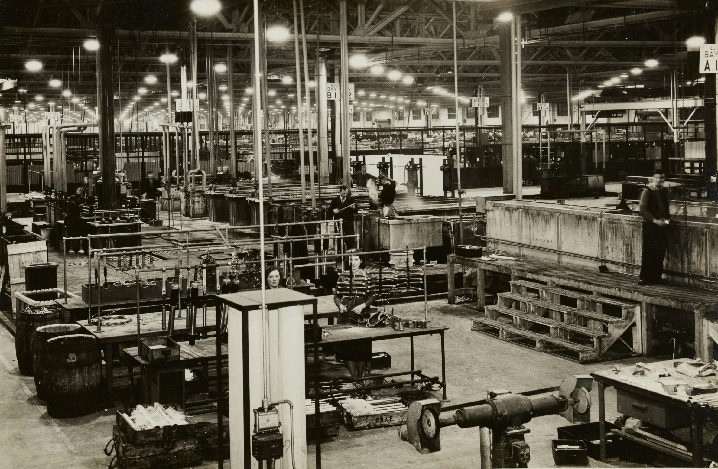 an industrial setting with lights and shelves full of objects