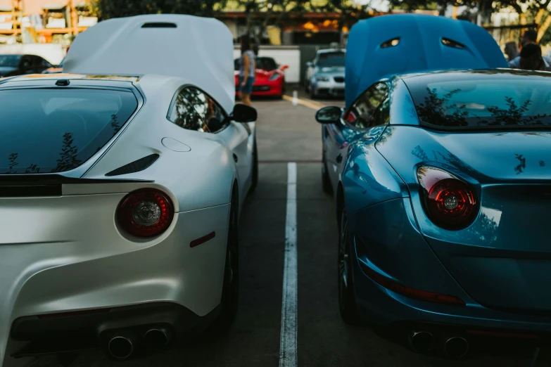 three sports cars parked in a parking lot
