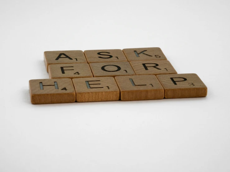 a close up of three small scrabble tiles