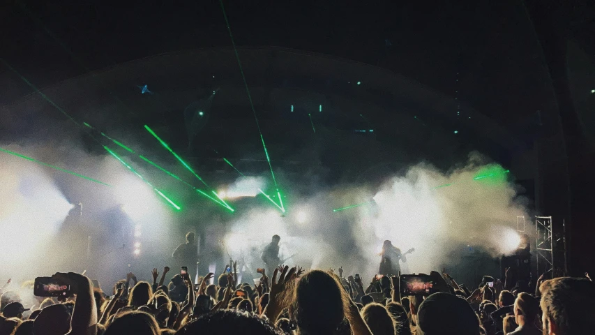 a concert with people at a big stage