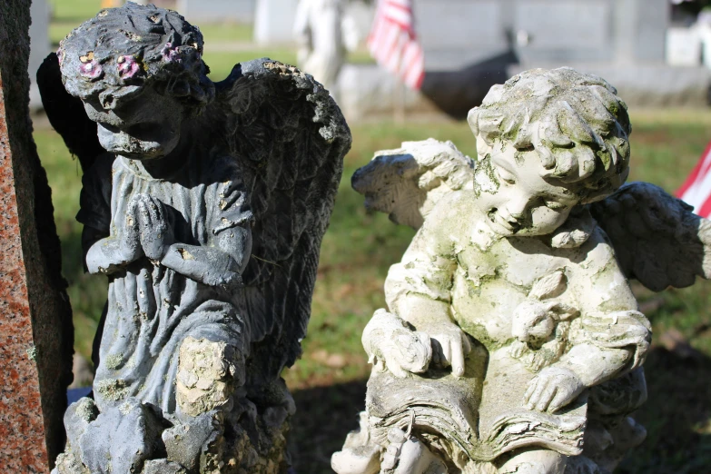 a stone statue sits in front of an american flag