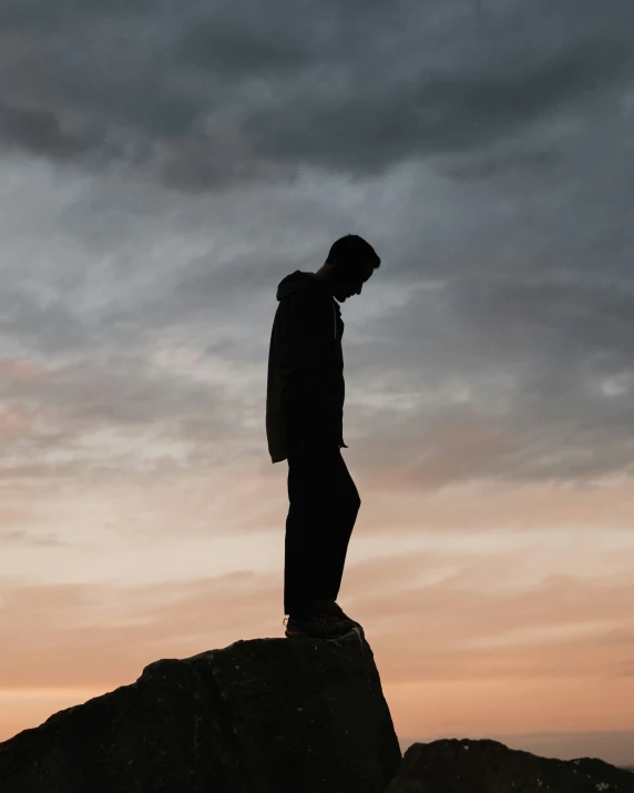 a man is standing on top of a rock