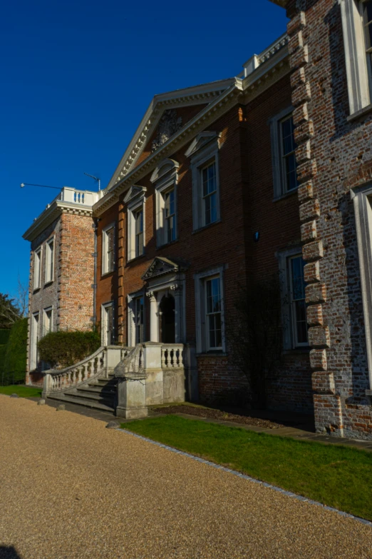 an old brick mansion with steps leading to it