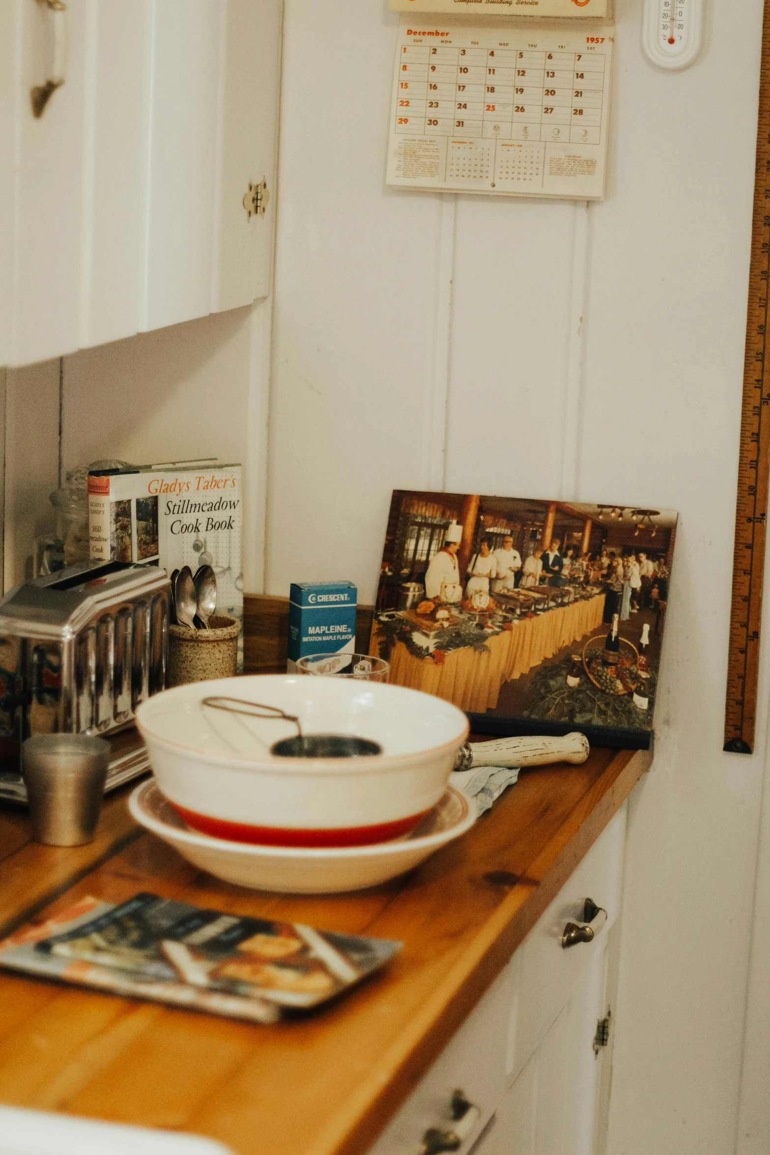 an old fashioned bowl and spoon sit on the edge of the kitchen counter