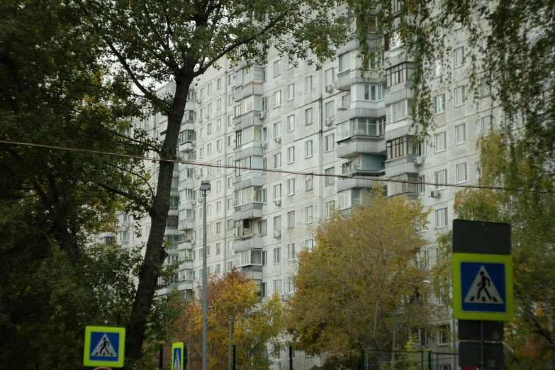 street view of a residential building with several parking signs