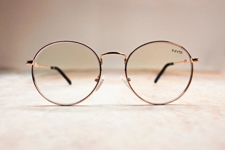 a pair of round metal frames are on top of a table