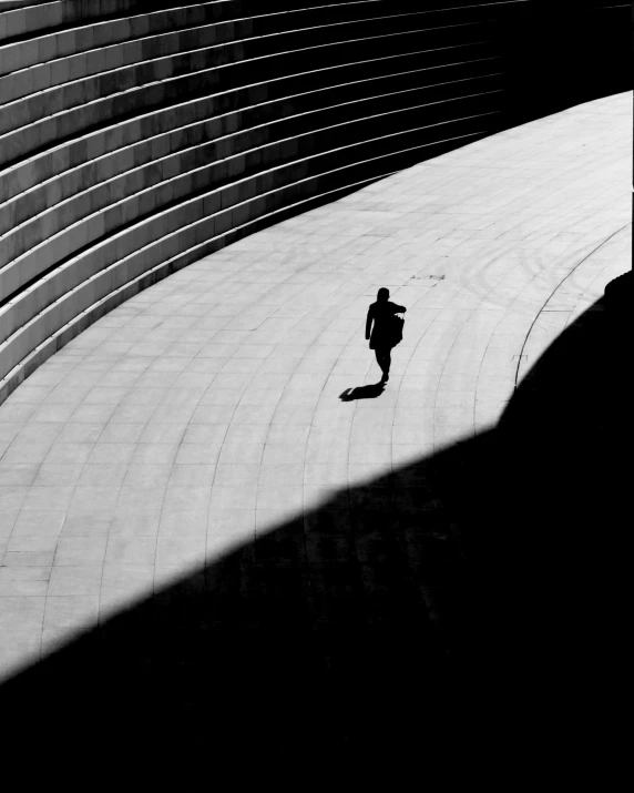 a man walking in the middle of a tunnel