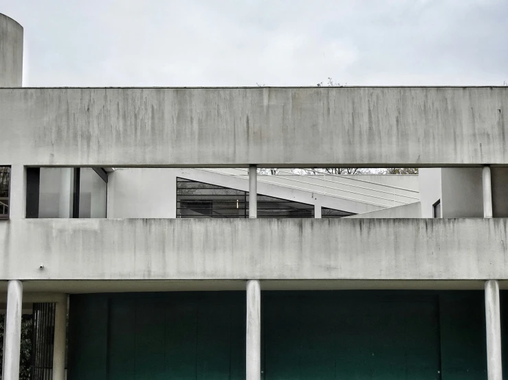 an empty building with columns and windows is viewed in the mirror