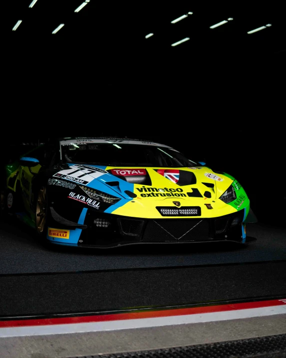 the front of a racing car with colorful paint on it