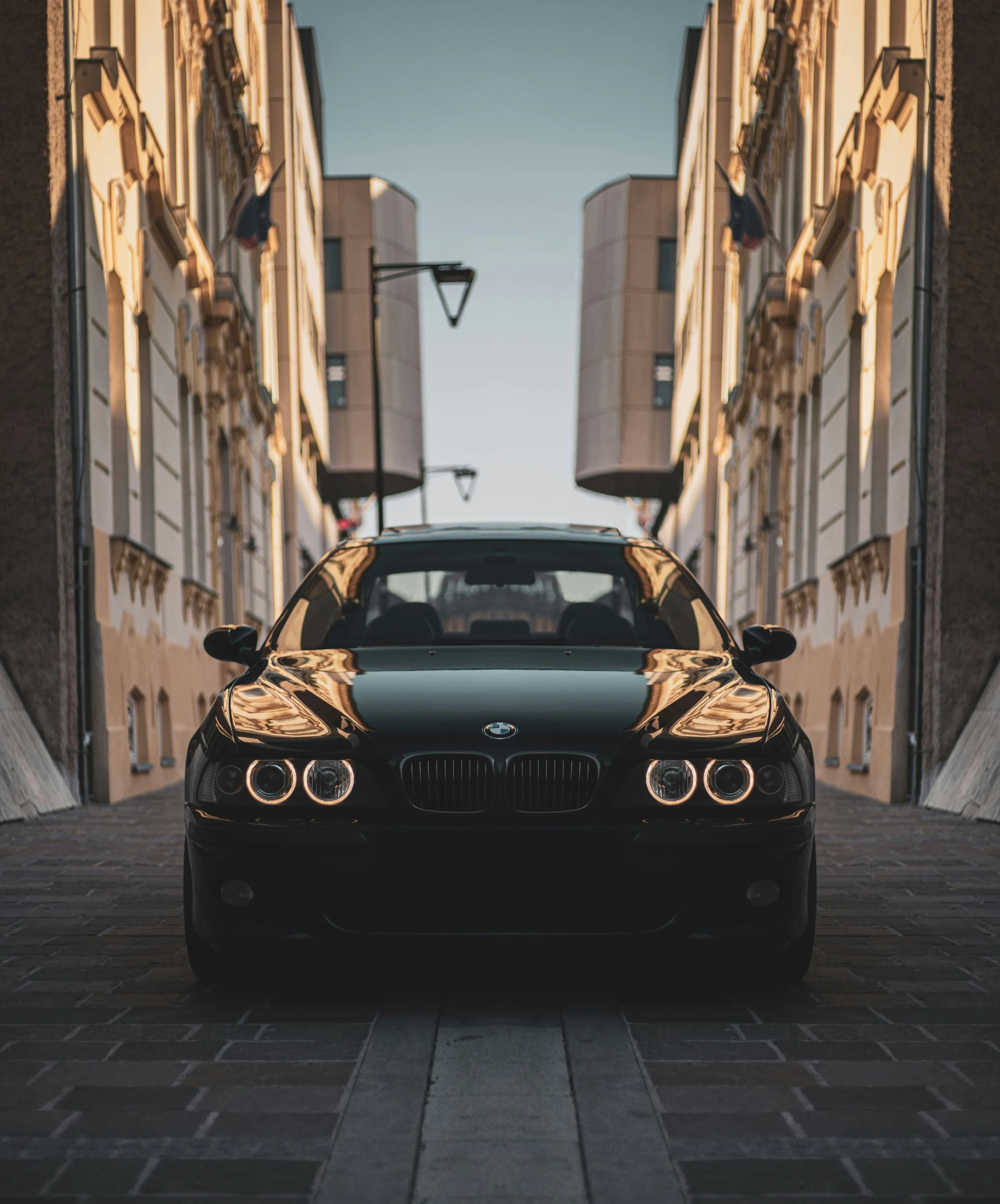 a black bmw with gold trim parked in the street