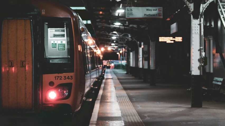 two trains parked at an empty train station