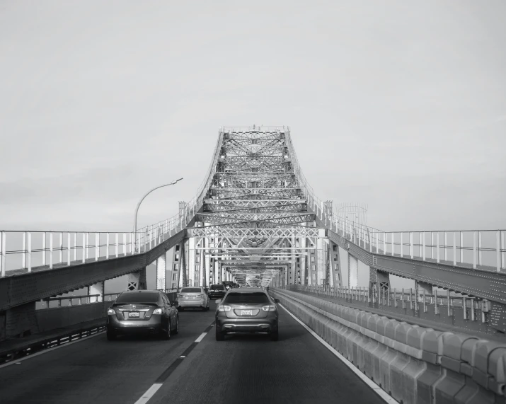 there are many cars on the bridge over water