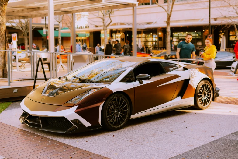 a brown and white lamb coupe is parked on the street