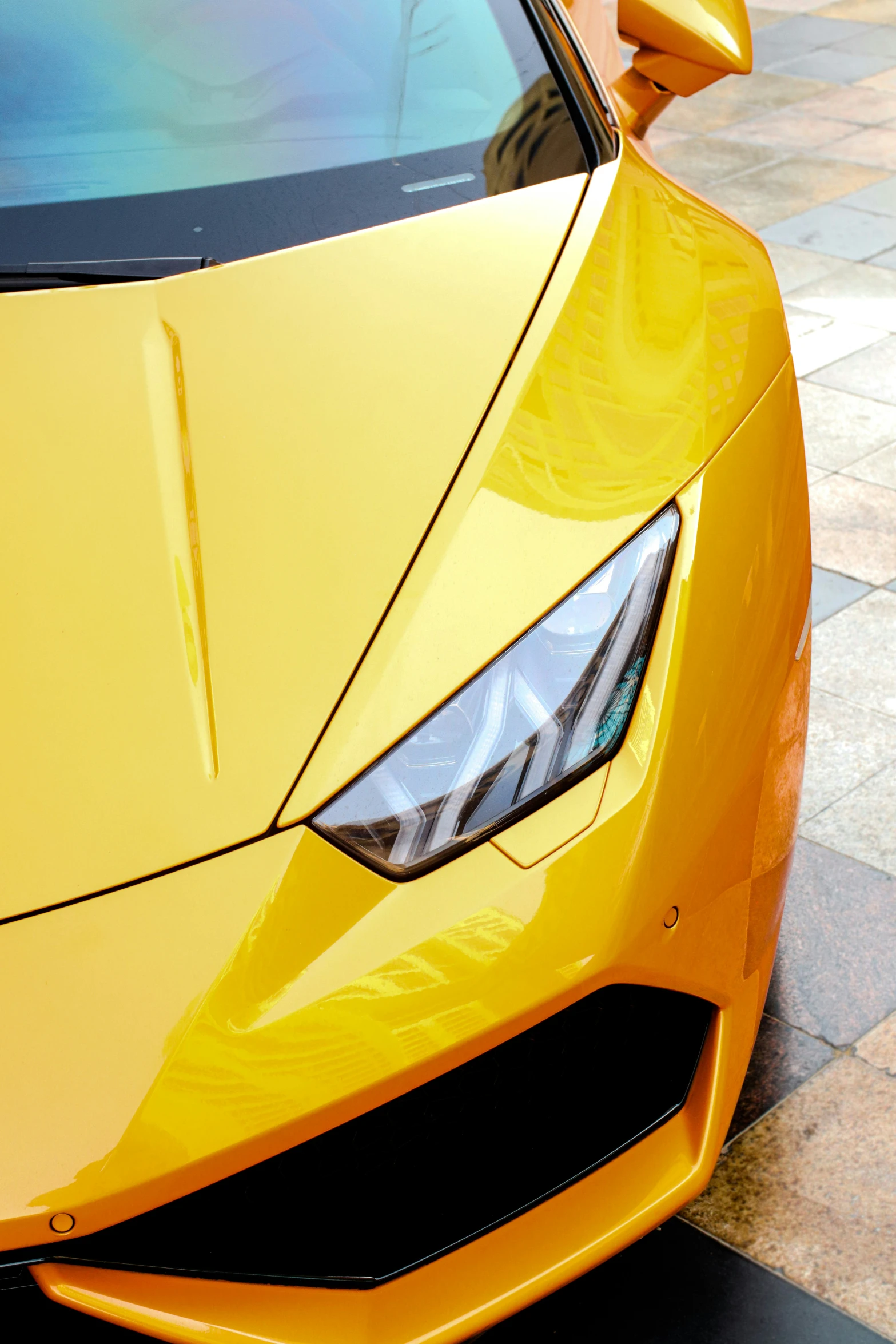 the front of a sports car in color yellow